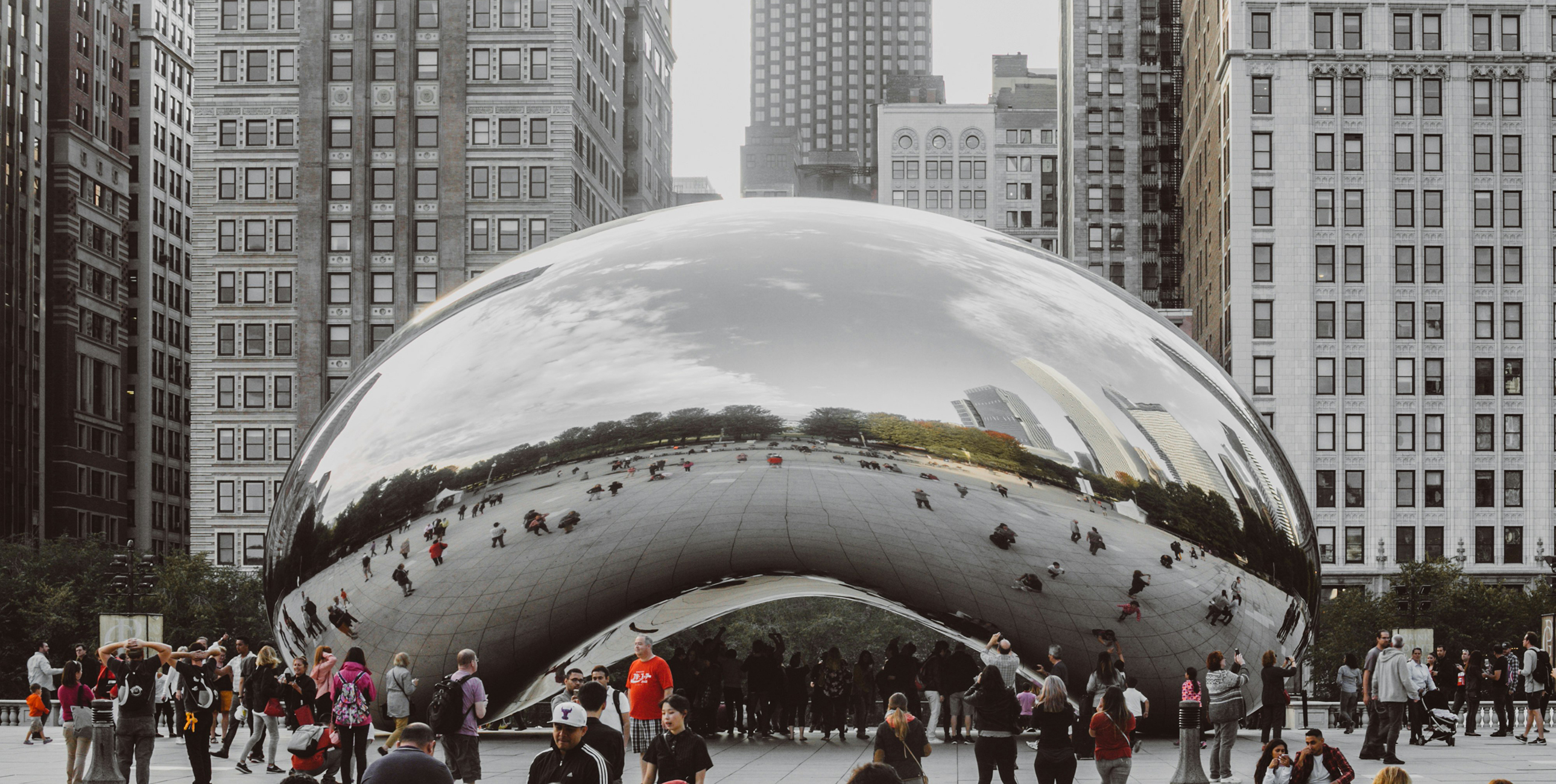 A photo of The Bean (Cloud Gate) sculpture in Chicago, Illinois, surrounded by people.